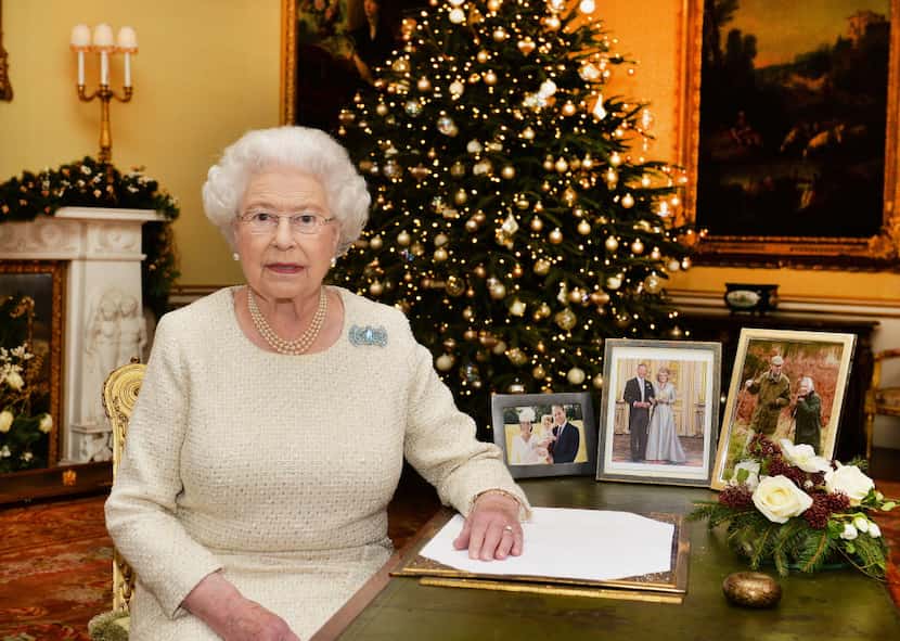 In this Dec. 10, 2015 photo, Britain's Queen Elizabeth II sits at a desk in the 18th Century...