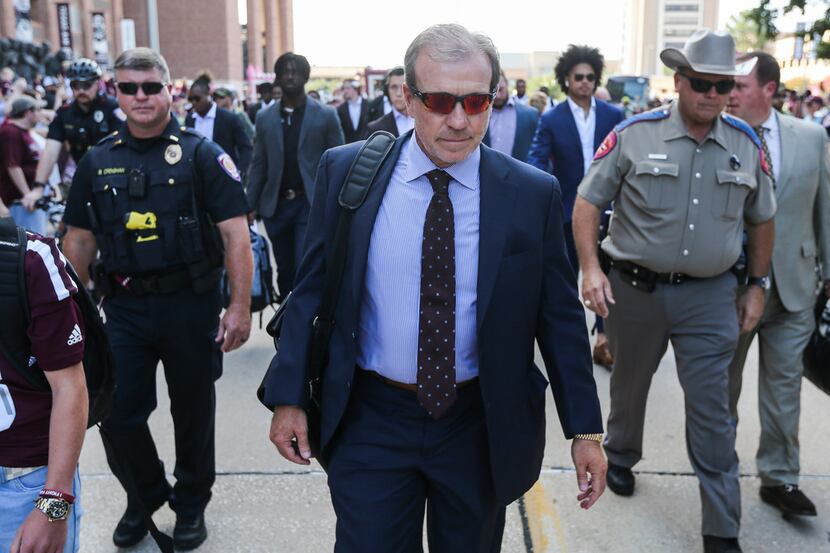 Texas A&M Aggies head coach Jimbo Fisher arrives with the team prior to a college football...