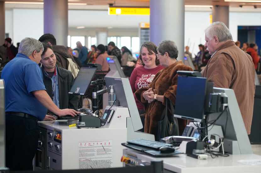 Travelers queue up at the check-in counters for Southwest Airlines in Denver International...
