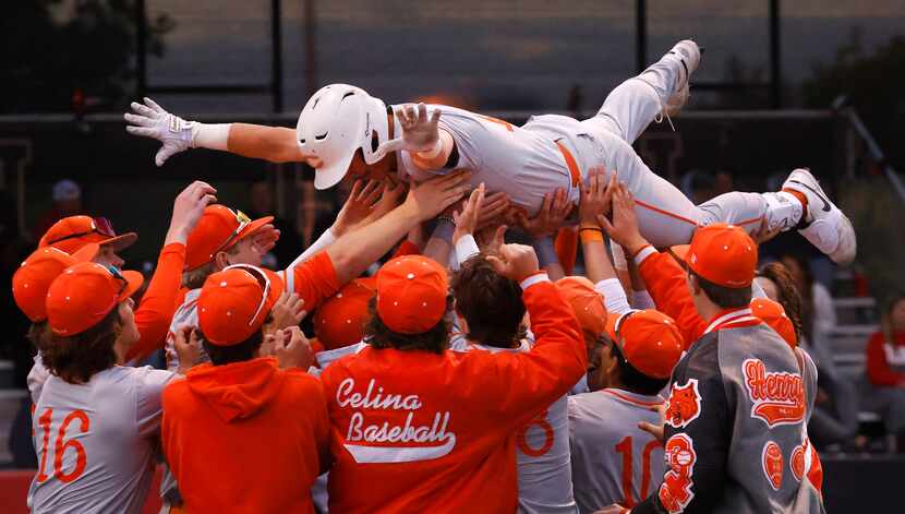 Celina's Kingston Hangartner (top) is congratulated by teammates after hitting a home run...