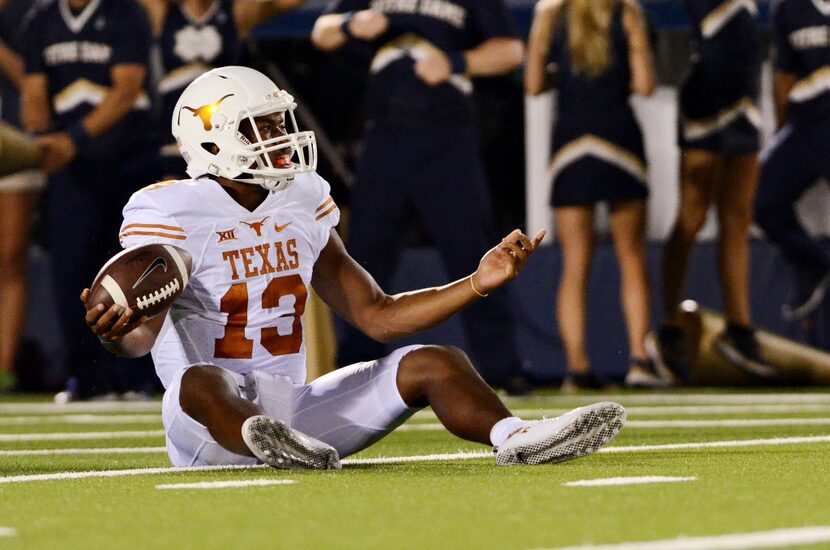 Texas quarterback Jerrod Heard reacts after being sacked by Notre Dame during an NCAA...