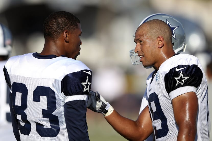 Dallas Cowboys wide receiver Miles Austin (19) talks with Dallas Cowboys wide receiver...