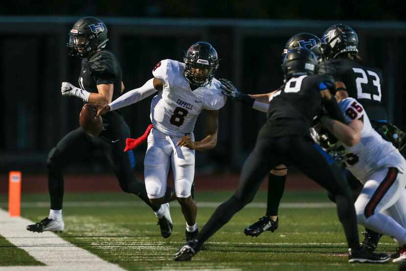 Coppell wide receiver Rasheed Noel (8) is driven out of bounds by Hebron defense during the...