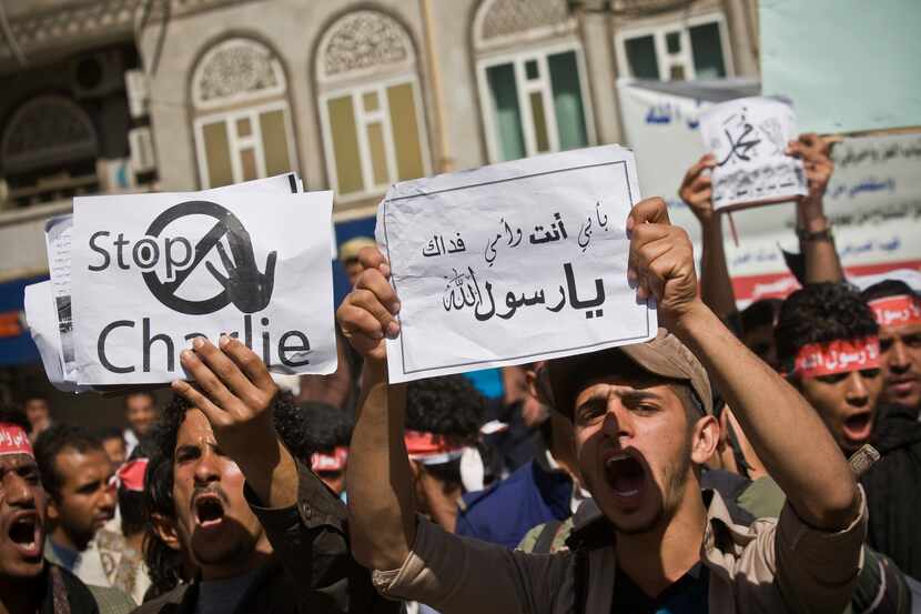 Yemenis chant slogans during a protest against caricatures published in French magazine...