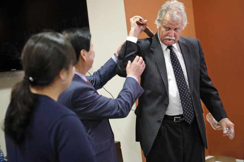 
Grand Prairie Mayor Ron Jensen tries out a Korean massage stick given to him by Mayor Sooil...