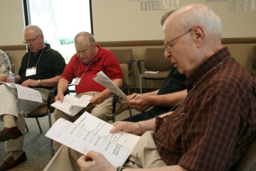 Jerry McMahan reads along with other group members for a vocal exercise during a Loud Crowd...