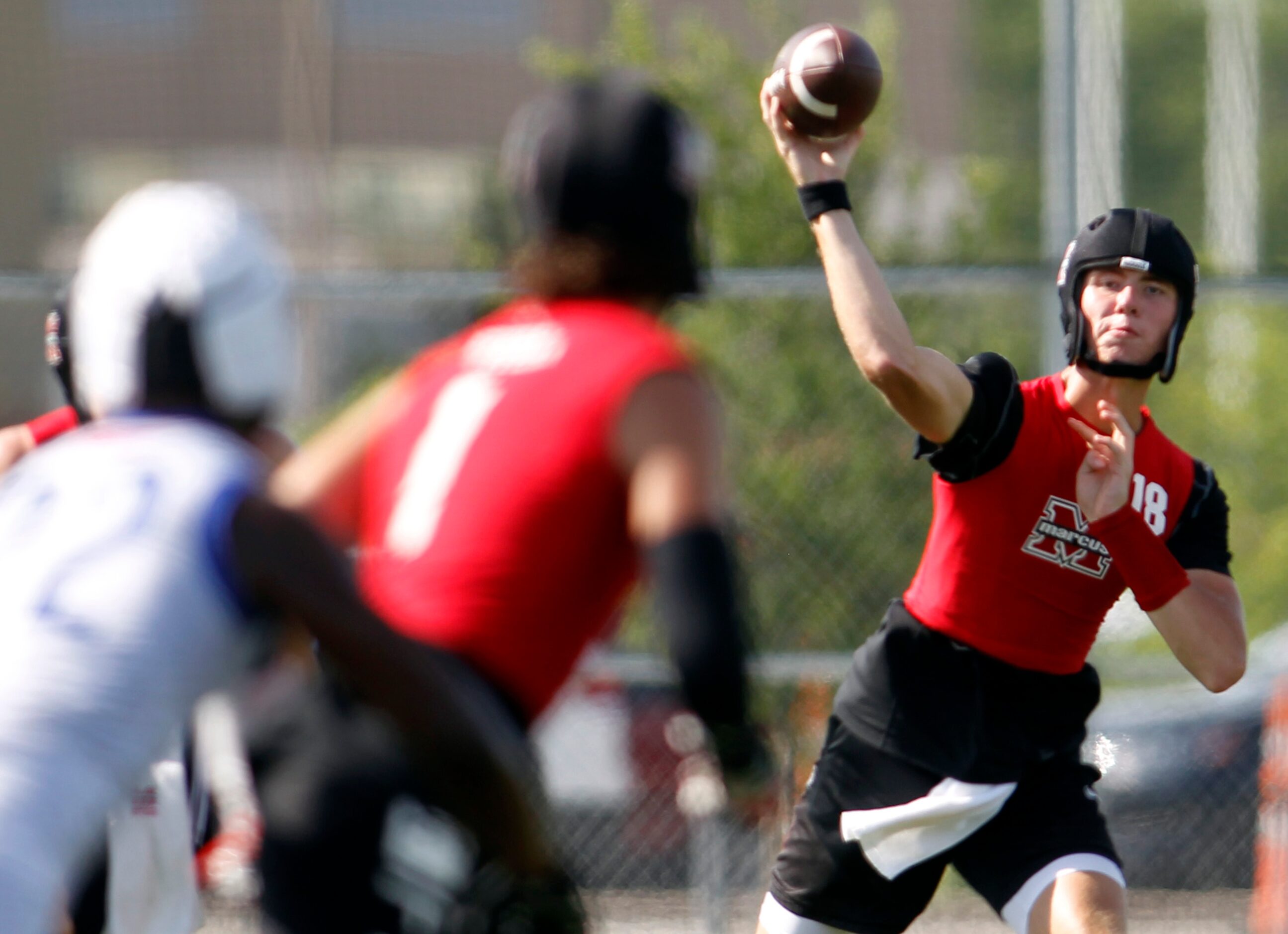 Flower Mound Marcus quarterback Cole Welliver (18) delivers a pass across the middle to a...