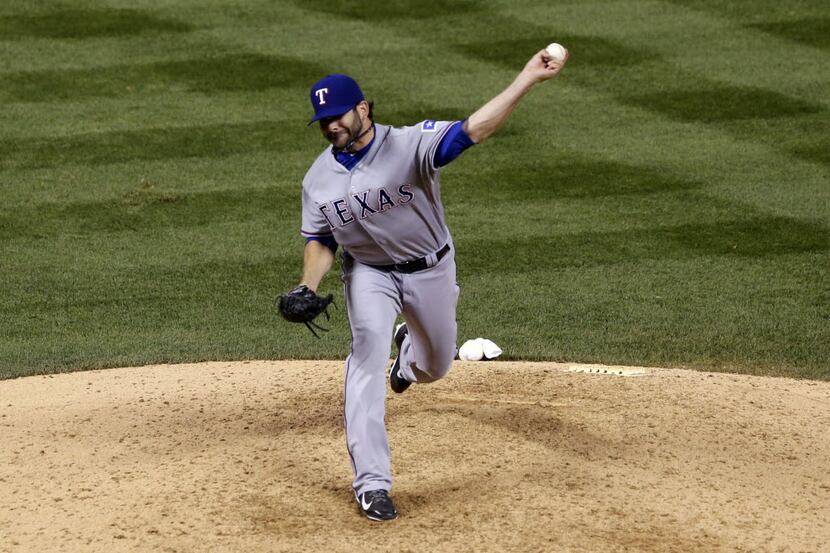 Texas Rangers outfielder Mitch Moreland fills in as a relief pitcher against the Colorado...