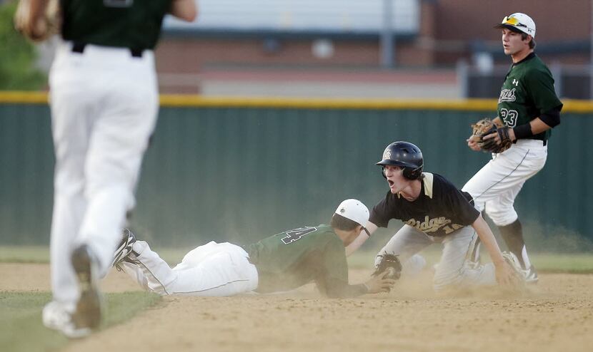Fossil Ridge freshman Dylan Neuse (16) reacts after being tagged by Southlake Carroll senior...