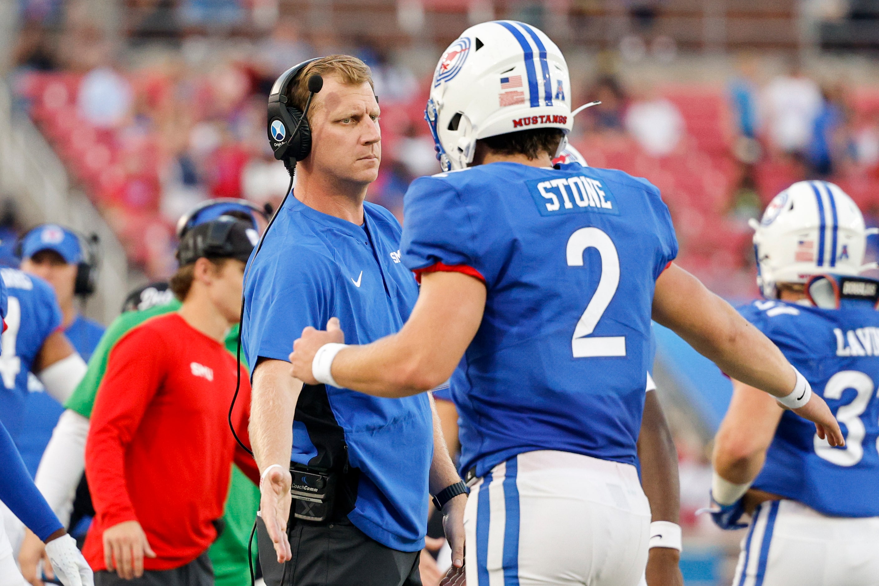 SMU quarterback Preston Stone (2) high-fives head coach Rhett Lashlee after scoring a...