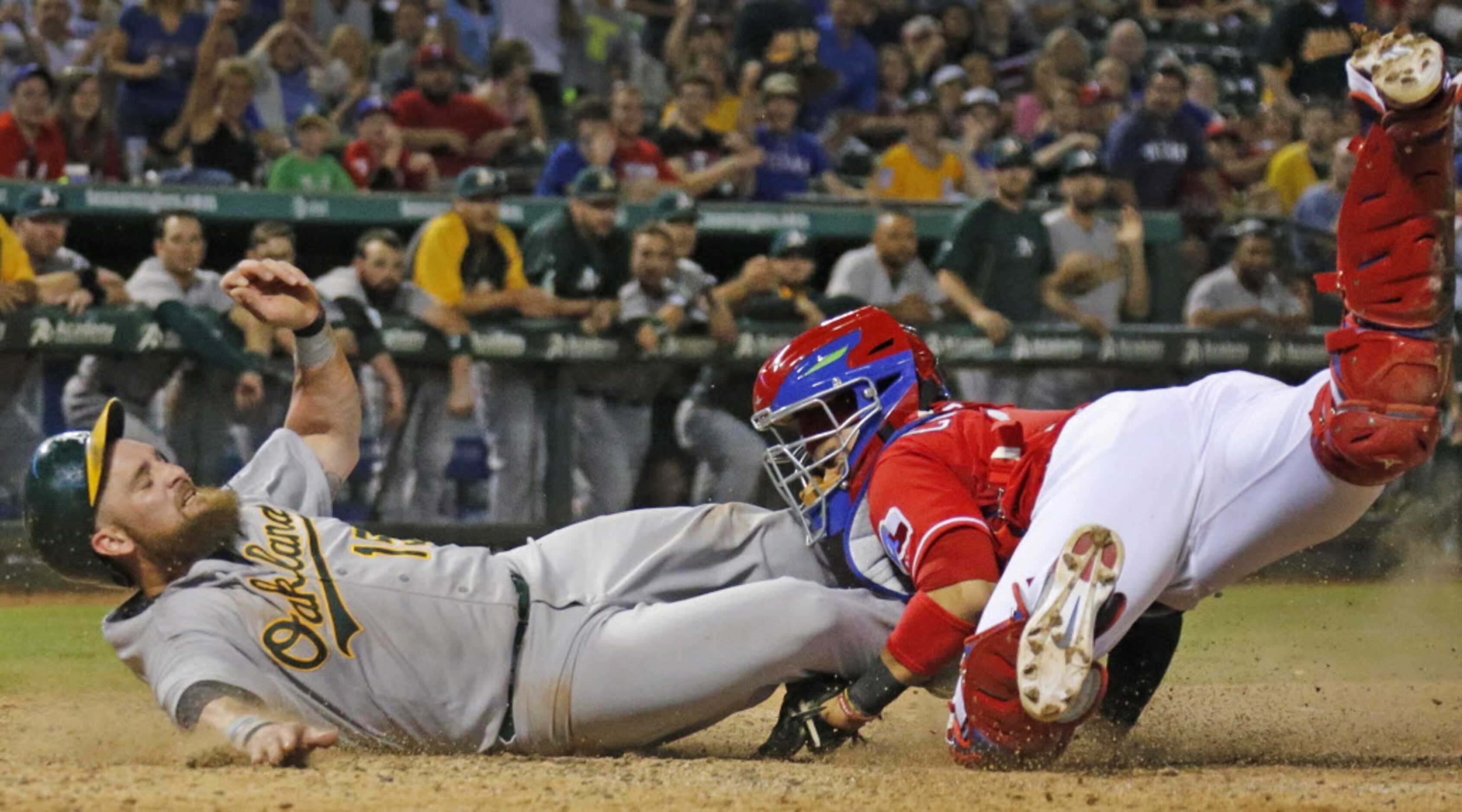 Oakland's Jonny Gomes is ruled safe at home as he scores on an eighth-inning single, as...