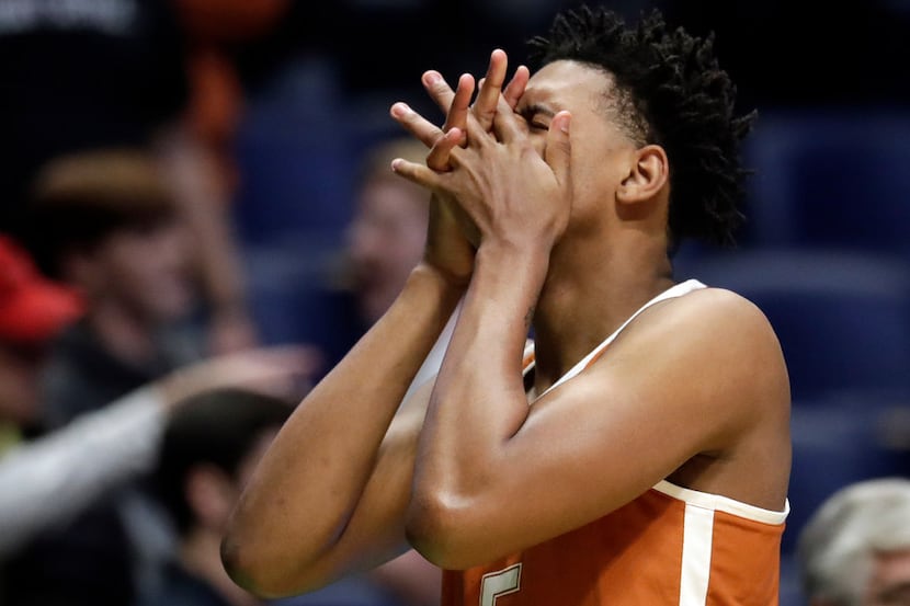 Texas forward Royce Hamm Jr. reacts after losing in overtime of a first-round game against...