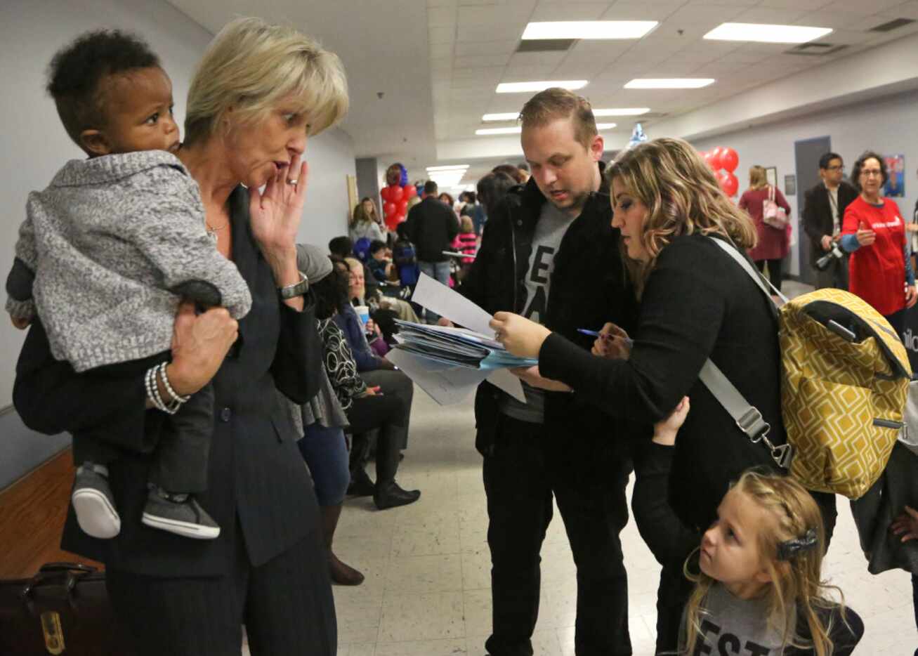 Attorney Shannon Lynch holds Rob and Caroline Carmack's soon-to-be adopted son, Abel Paul....