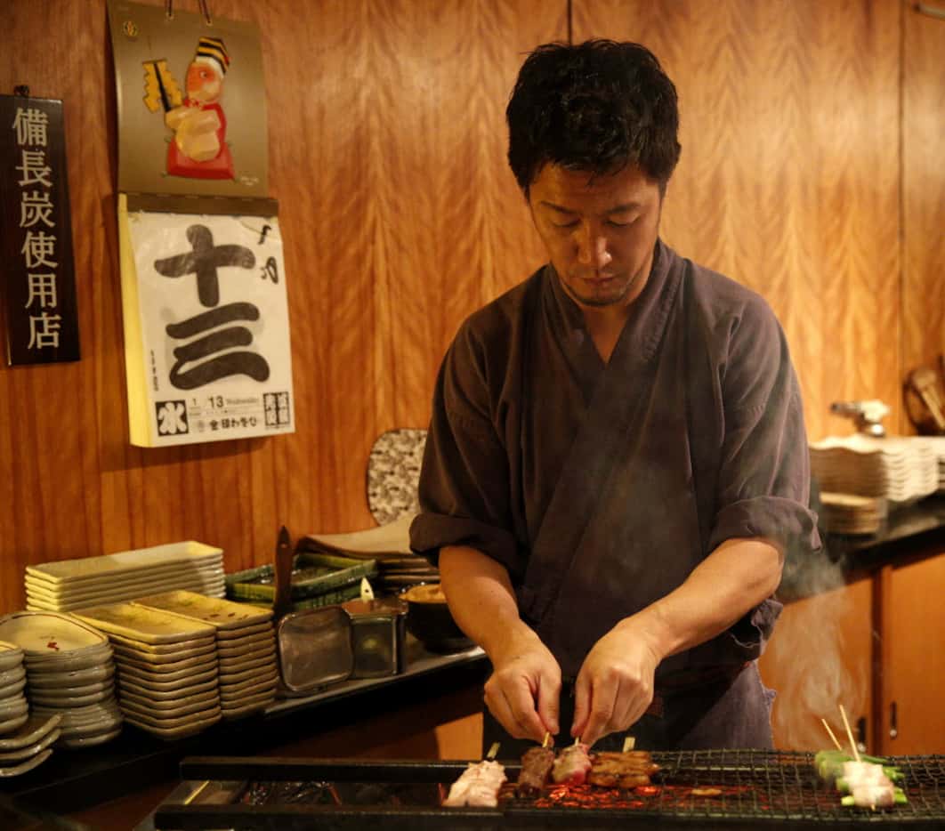 Chef-owner Masayuki Otaka mans the yakitori grill, with its superhot binchotan (Japanese...