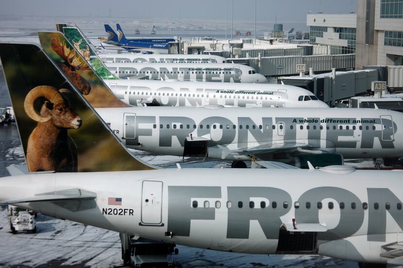 FILE - In this Feb. 22, 2010 file photo, Frontier Airlines jetliners sit stacked up at gates...