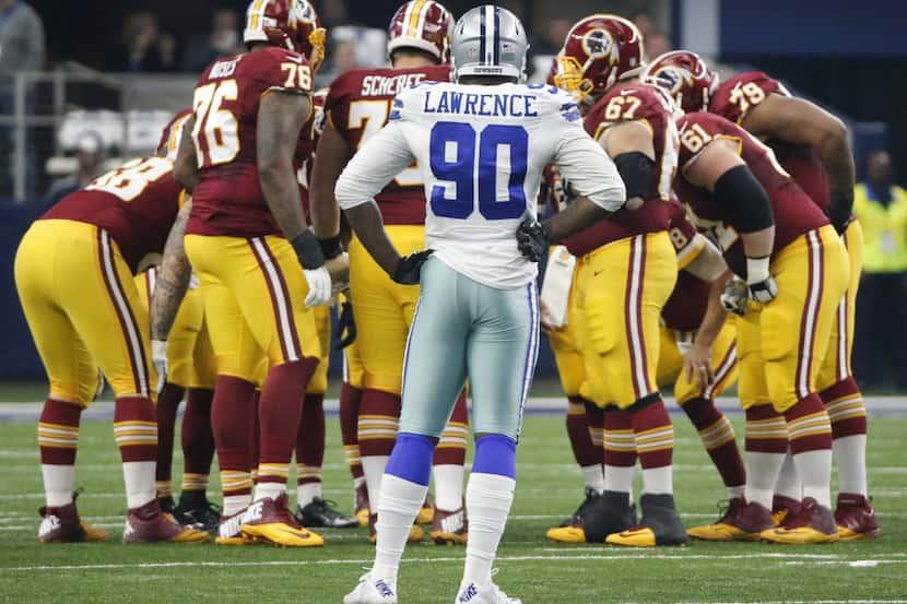 Dallas Cowboys defensive end Demarcus Lawrence (90) watches as Washington huddles on offense...