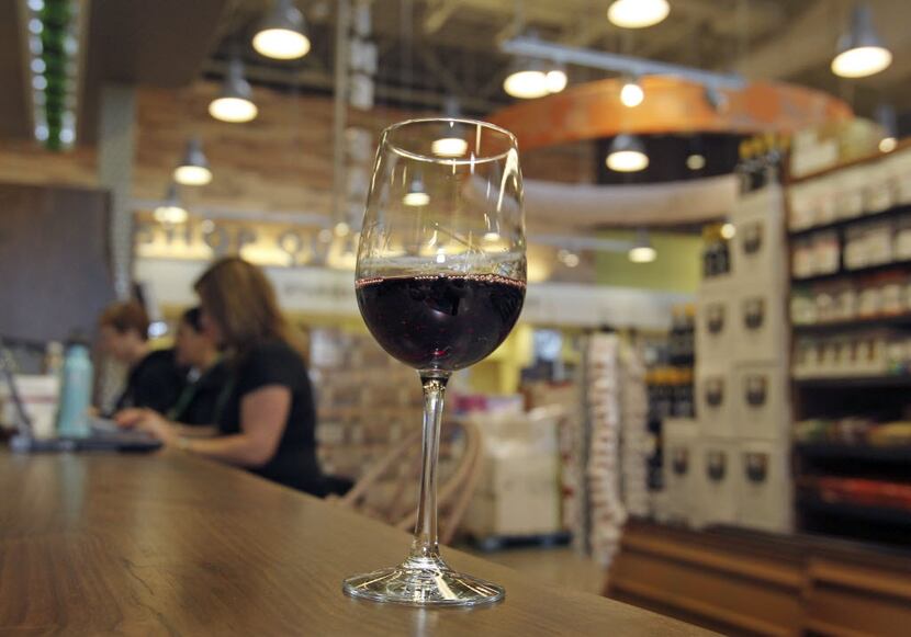 Patrons at Whole Foods grocery stores in D-FW can wander the store sipping wine. As of early...