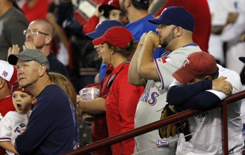 Texas Rangers fans dejected during the ninth inning of the American League wild card playoff...