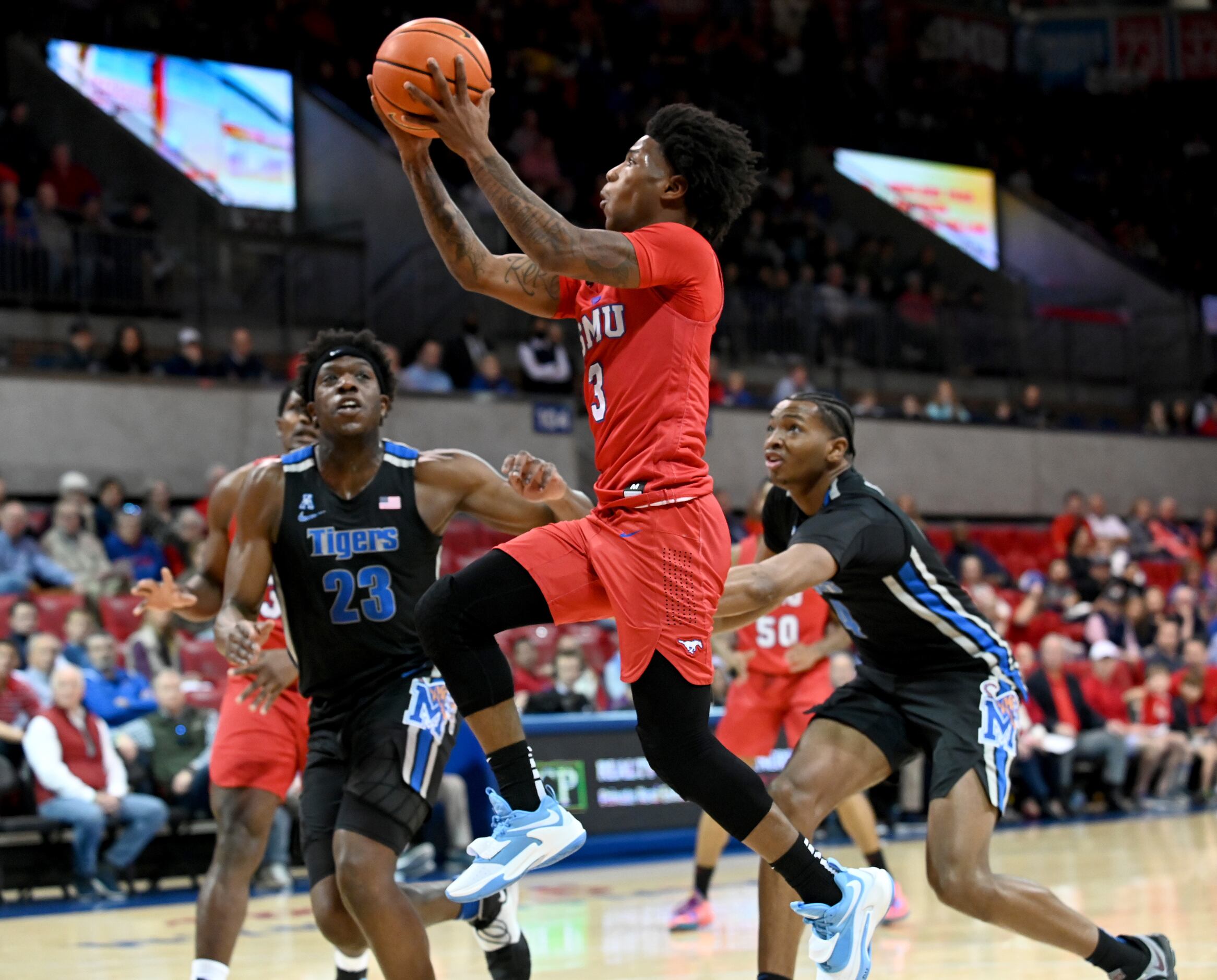 SMU guard Kendric Davis (3) drives to the basket in front of Memphis center Malcolm...
