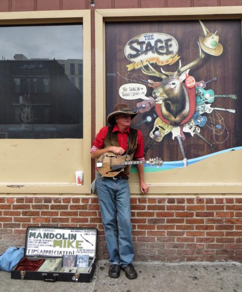 
Busker Mandolin Mike takes a break on Honky Tonk Row.
