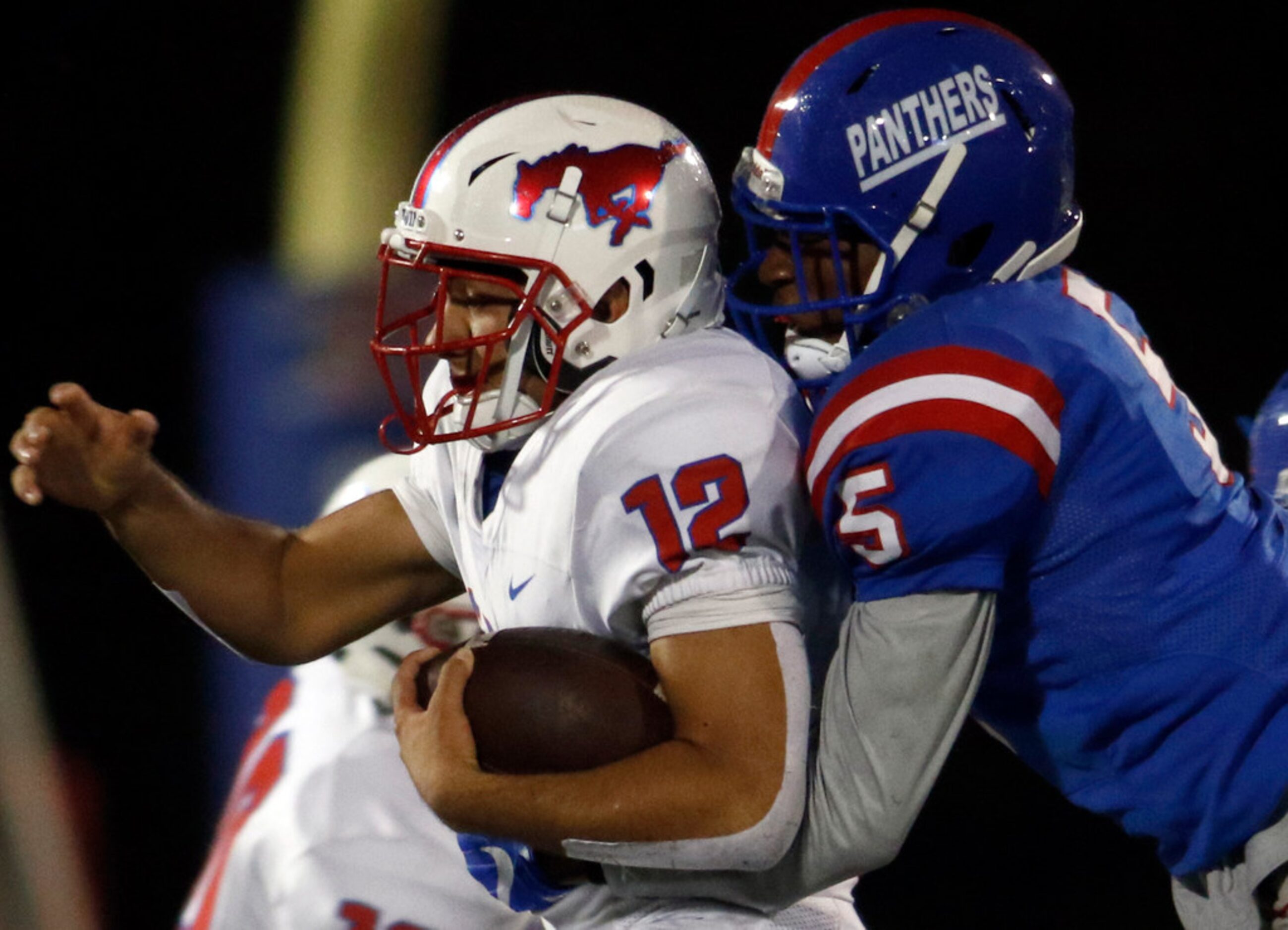 Richardson Pearce running back Pablo Valazquez (12) is tackled by Duncanville defensive back...