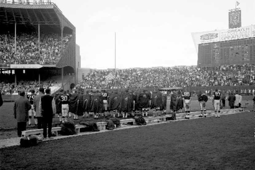 Players and fans at Cleveland Municipal Stadium pause for a moment of silence in honor of...