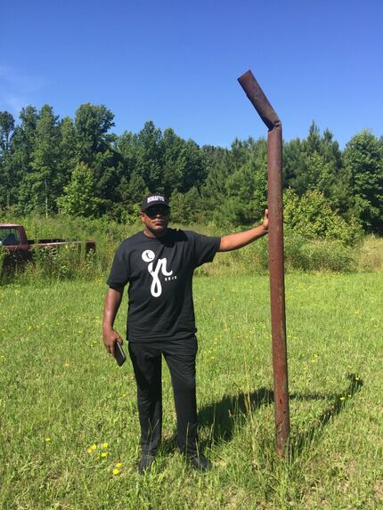 Dennis Smith Sr. stands at all that's left of the basketball goal where Dennis Jr. began...