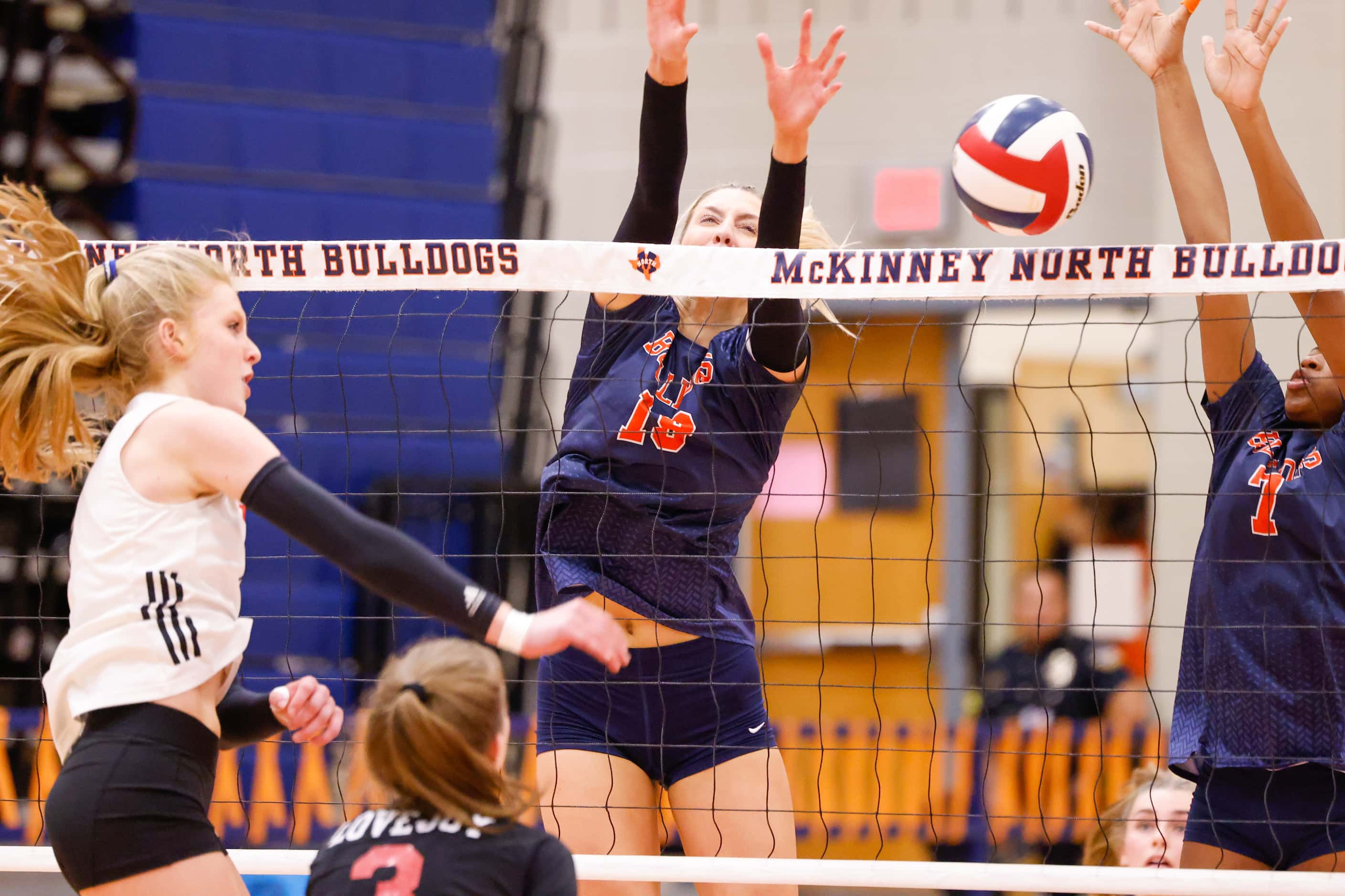 McKinney North Natalie Hughes (19) and Kaitlyn Jefferson (7) jump to block a spike by...