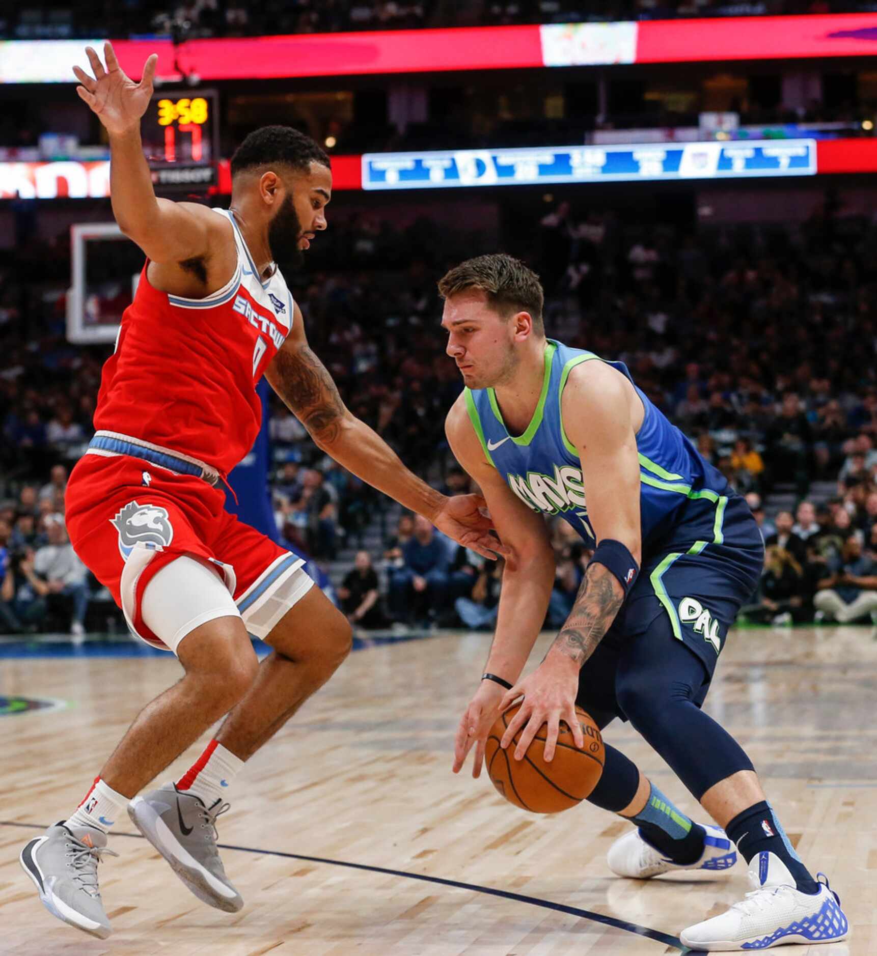 Dallas Mavericks forward Luka Doncic (77) drives past Sacramento Kings guard Cory Joseph (9)...