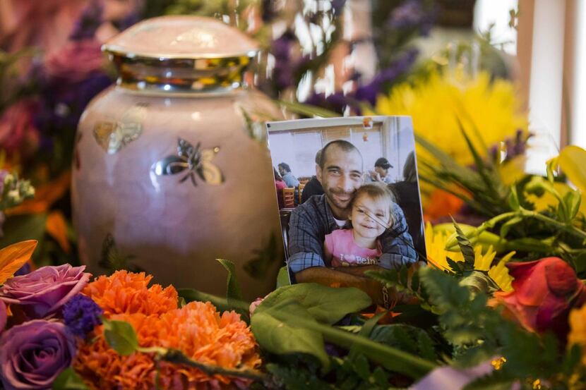 
A pink urn holds the remains of Leiliana Rose Wright, 4, shown in a photograph with her...