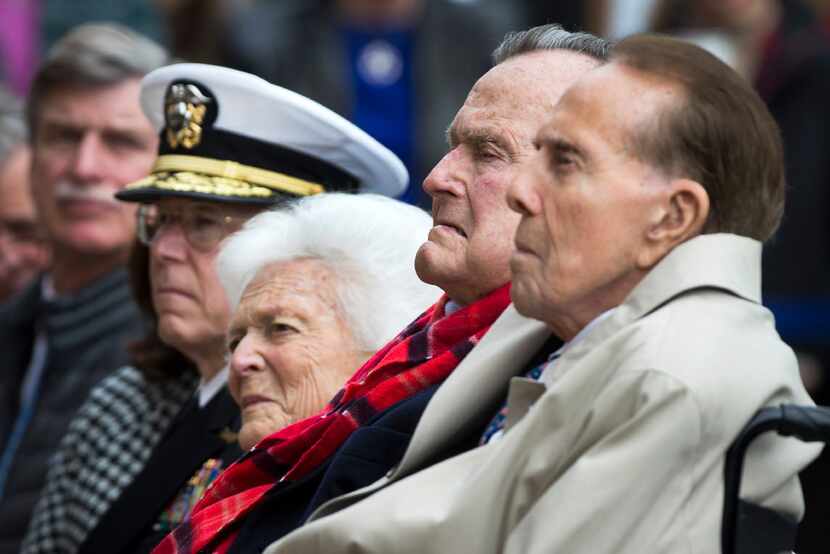 Former President George H.W. Bush and former Senator Bob Dole sat with Barbara Bush and...