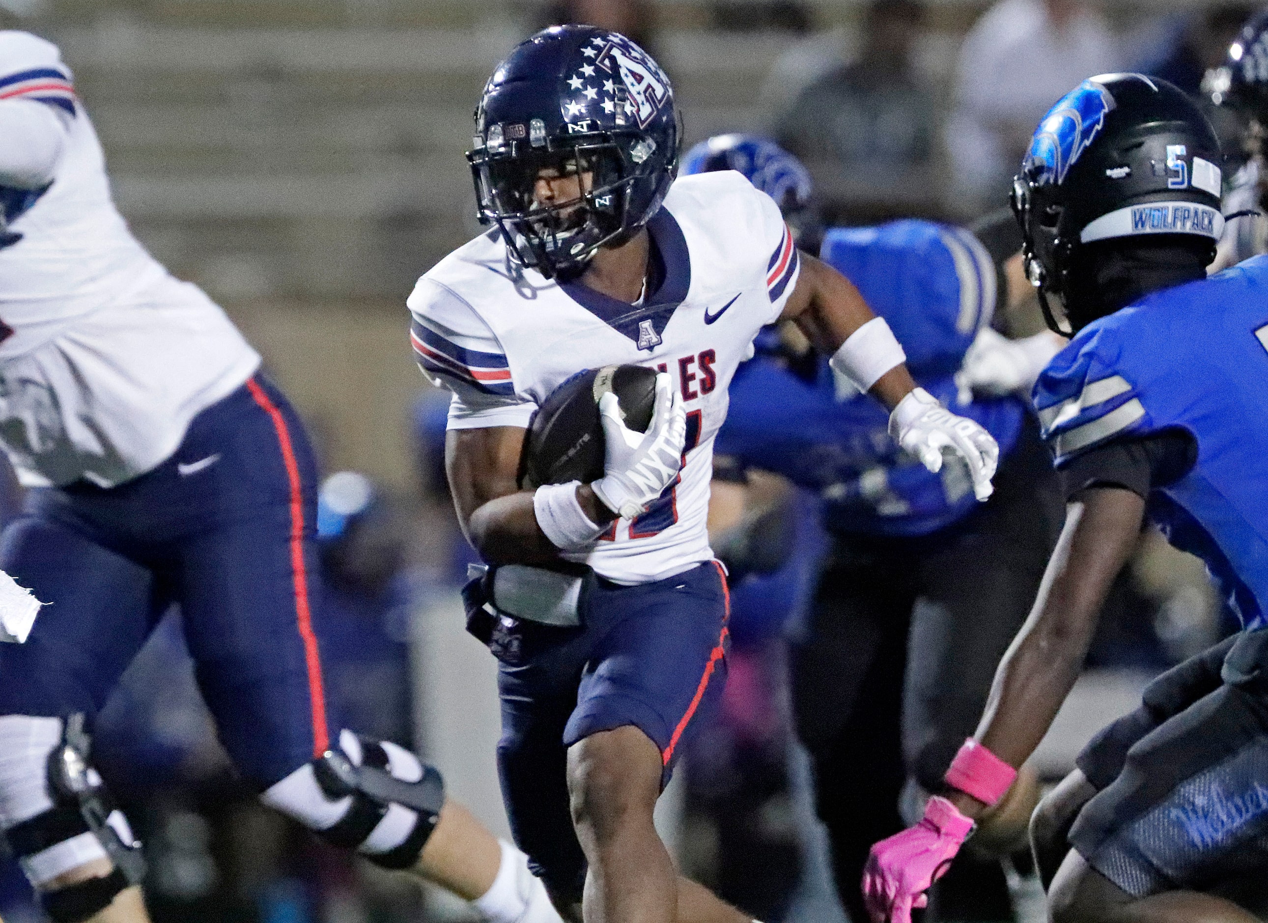 Allen High School running back Lyndon Spriggs (11) gets yardage during the first half as...