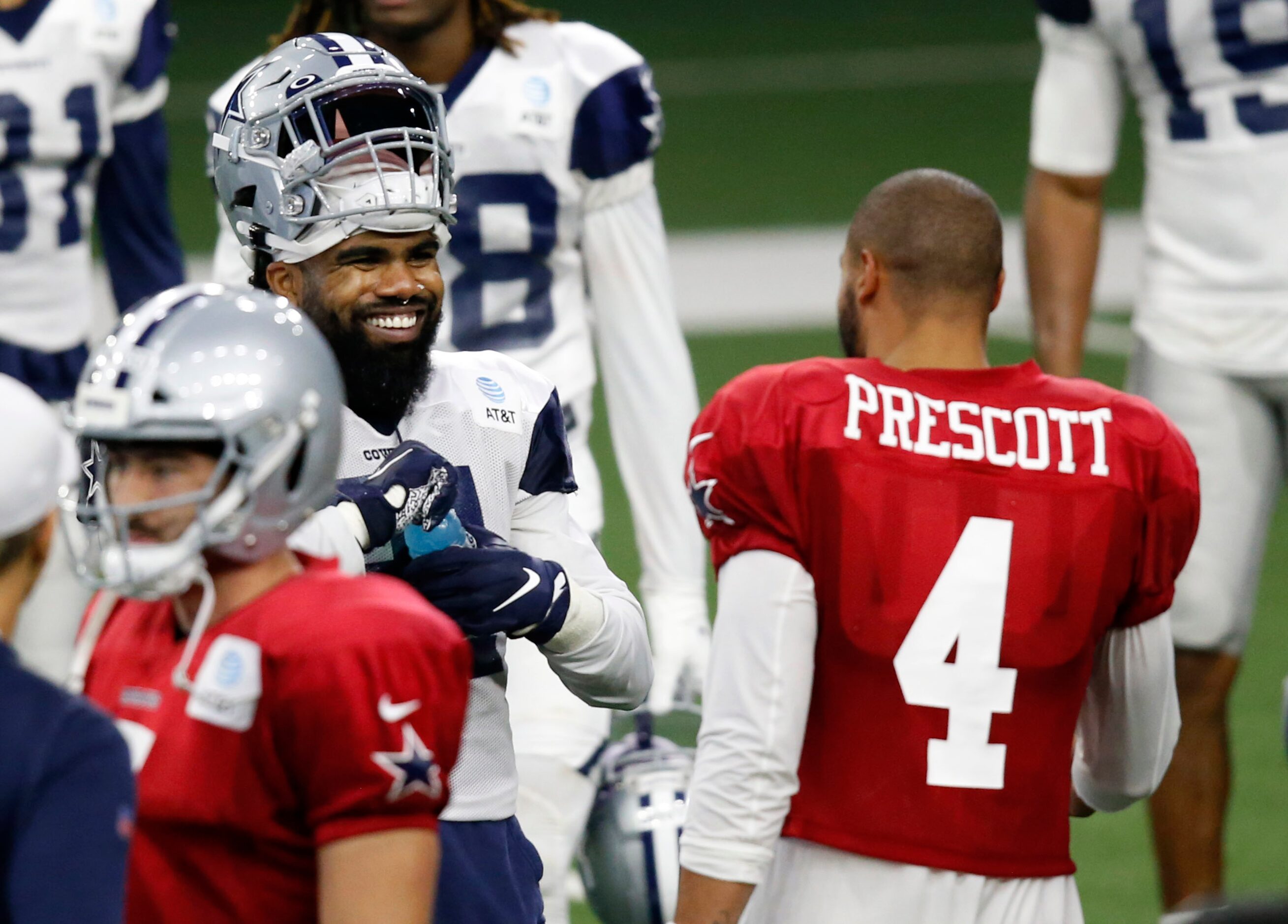 Dallas Cowboys running back Ezekiel Elliott (21) smiles as he talks to Dallas Cowboys...