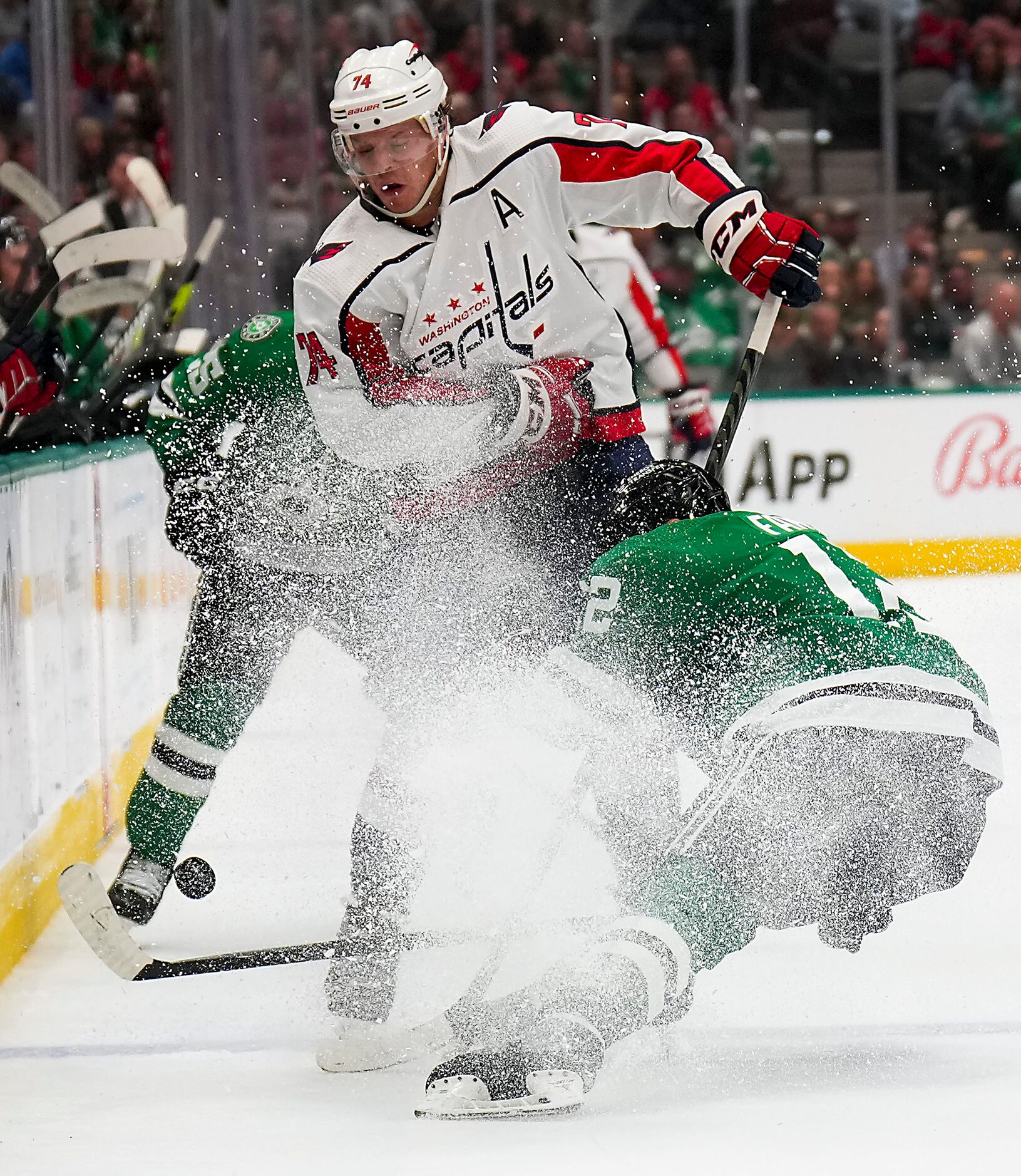 Dallas Stars center Radek Faksa (12) gets tied up along the boards with Washington Capitals...