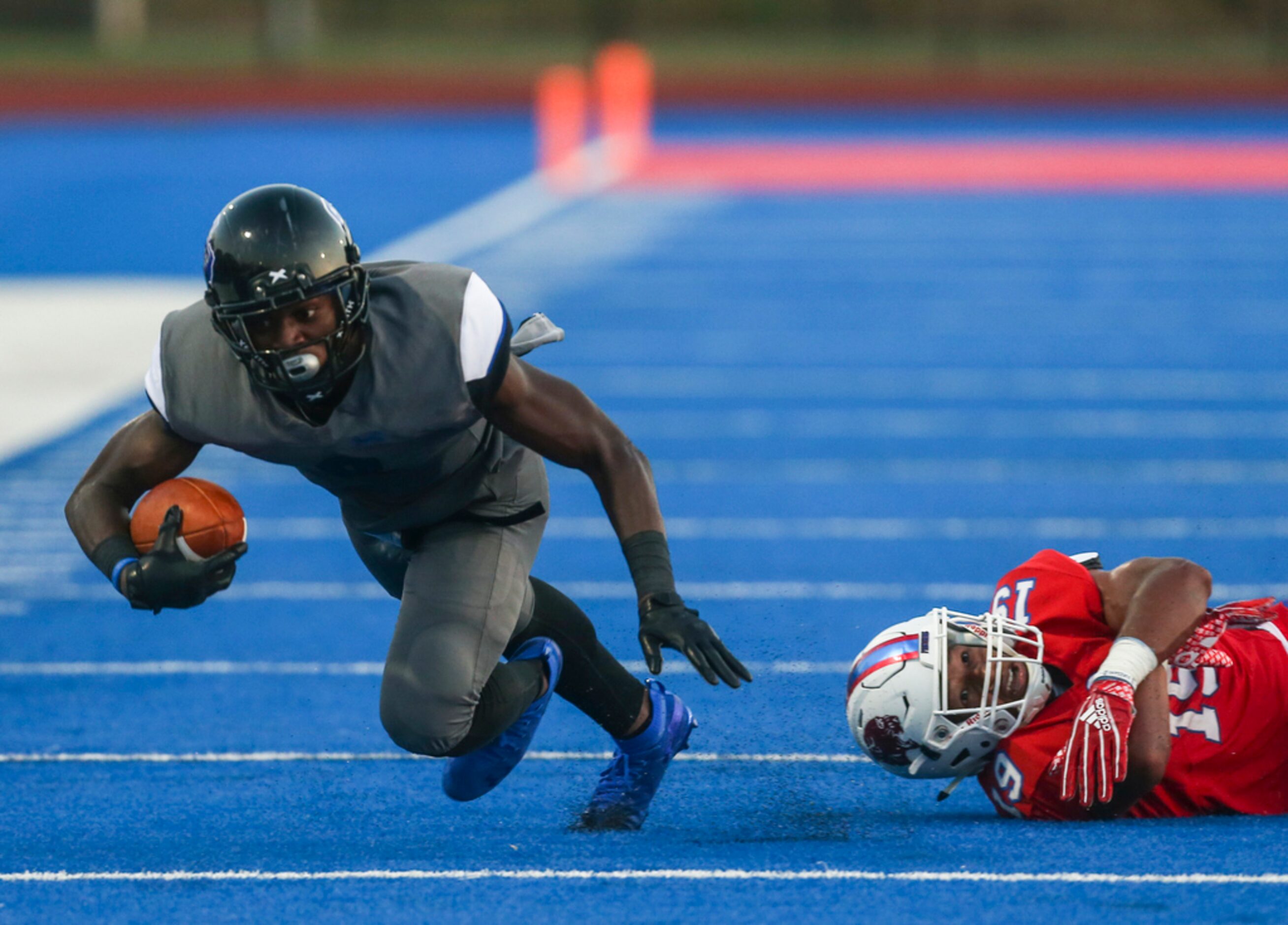 Trinity Christian-Cedar Hills strong safety Marques Buford (8) lands a pass over Parish...