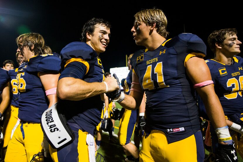 Highland Park quarterback John Stephen Jones (9) celebrates with defensive lineman Elliott...