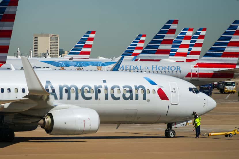 American Airlines planes are seen at the gates of Terminal C at DFW Airport on Tuesday, Feb....