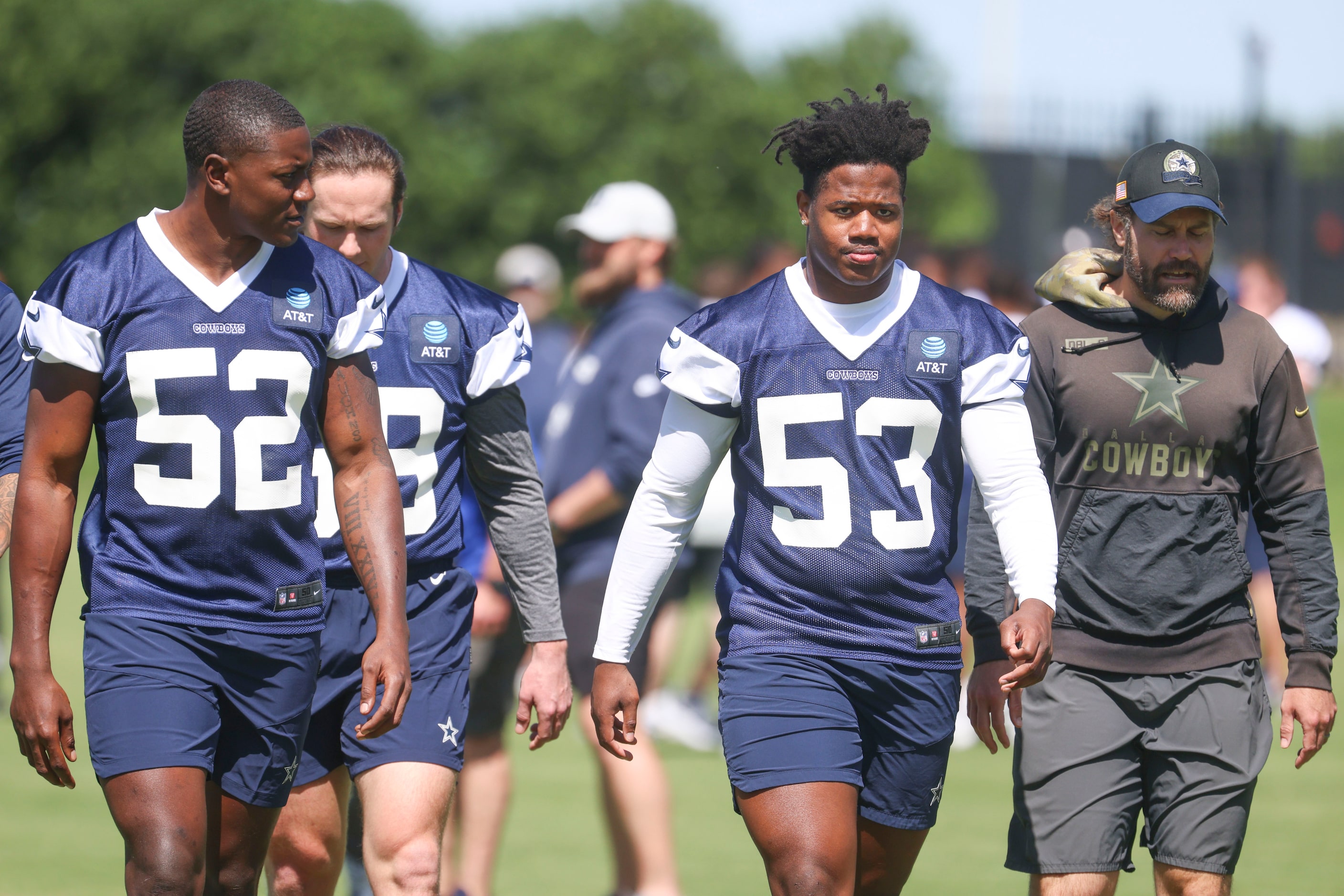 Dallas Cowboys linebackers Byron Vaughns (52), and Jason Johnson (53) exit the field during...