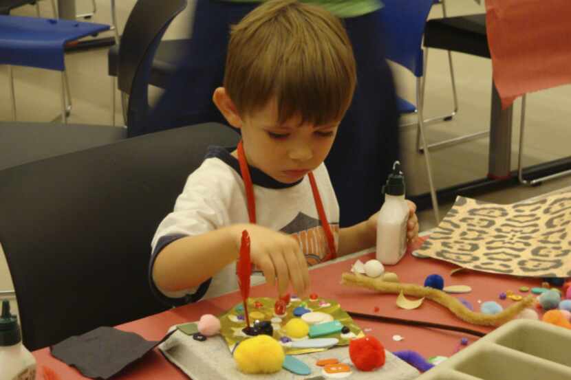 A child makes art at a summer camp hosted by the Dallas Museum of Art. The Irving Arts...