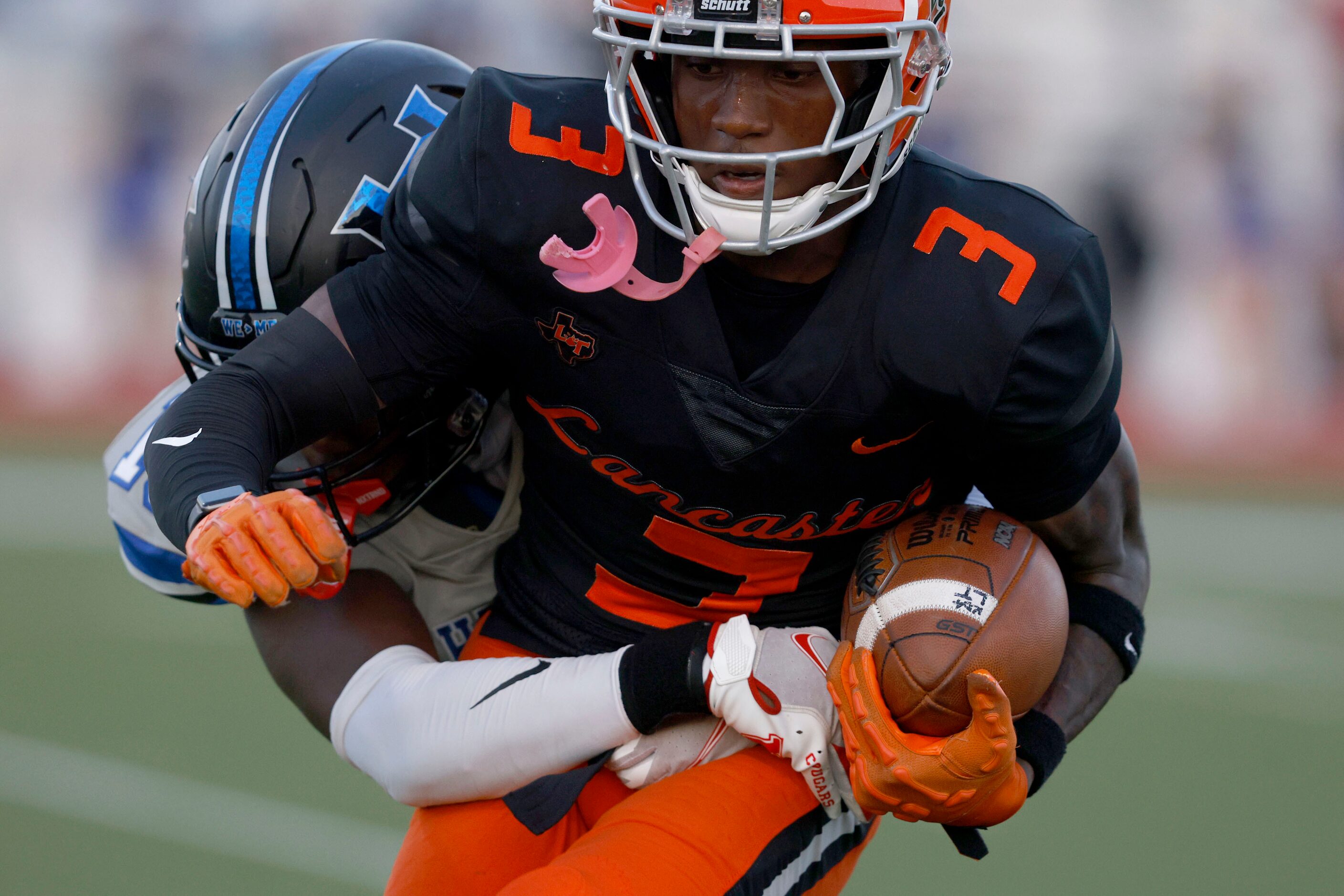 Lancaster’s Ja’Quavius Pipkin (3) is tackled by Hebron’s Kylan Smart (19), behind, in the...