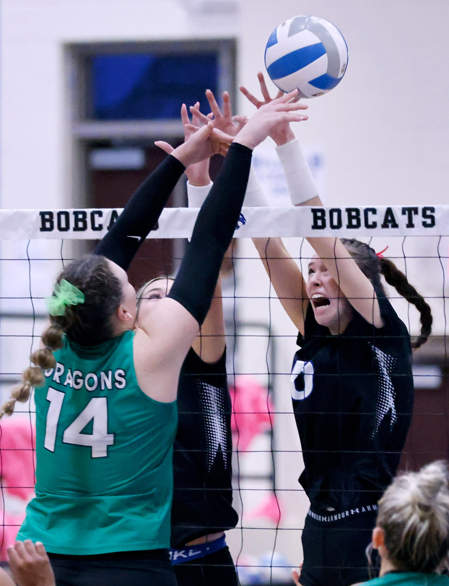 Southlake Carroll middle blocker Kinsley Young (14) pushes the ball over Trophy Club Byron...