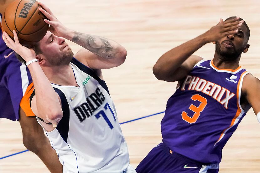 Phoenix Suns guard Chris Paul (3) falls backwards as he is fouled by Dallas Mavericks guard...