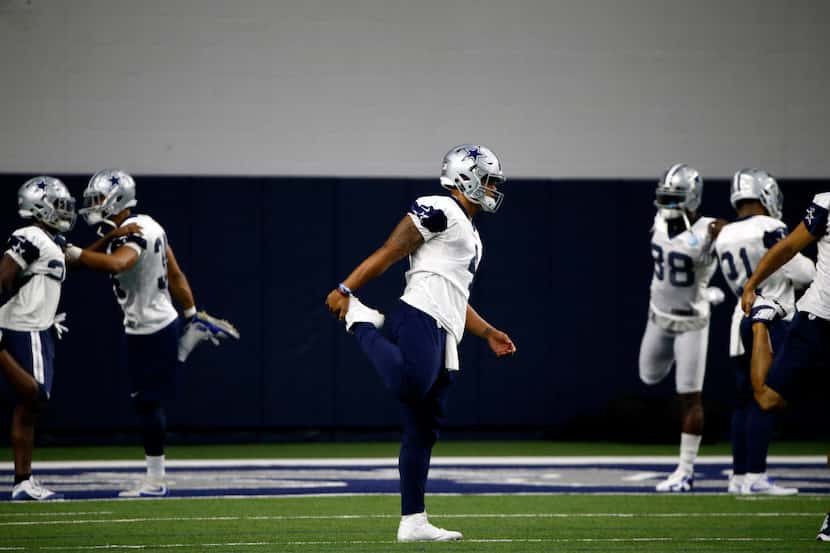Dallas Cowboys quarterback Dak Prescott (4) stretches during practice at The Star in Frisco,...
