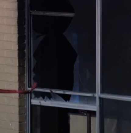 A broken window at the scene of the apartment fire on Castleglen Drive.