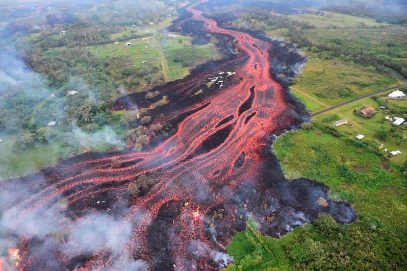 In this Saturday, May 19, photo released by the U.S. Geological Survey, lava flows from...