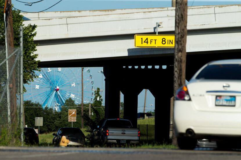 Cars drive south on 2nd Ave. passing under Interstate 30 heading away from the Deep Ellum...