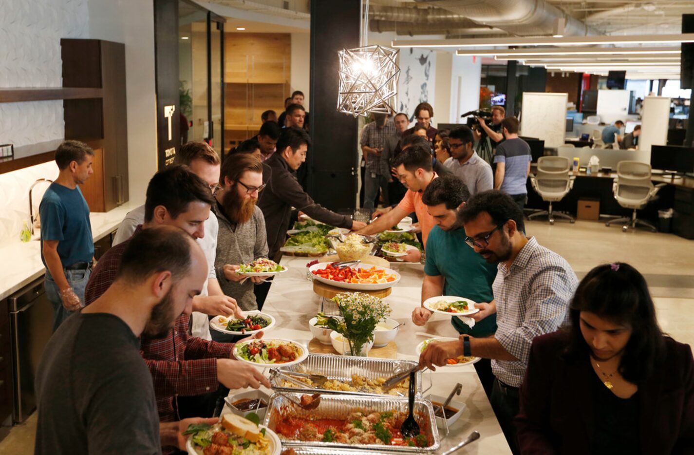 Employees make lunch from the daily company provided buffet at Toyota Connected in Plano on...