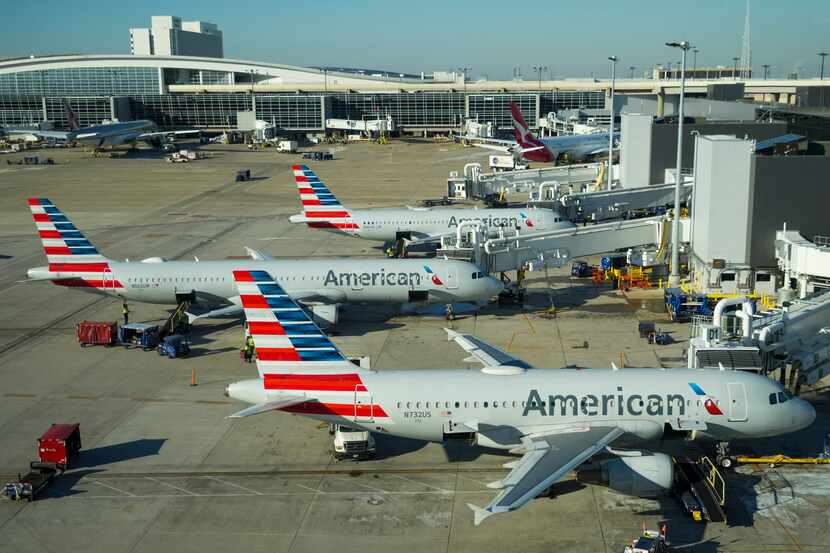 American Airlines planes are seen at the gates of Terminal D at DFW Airport.