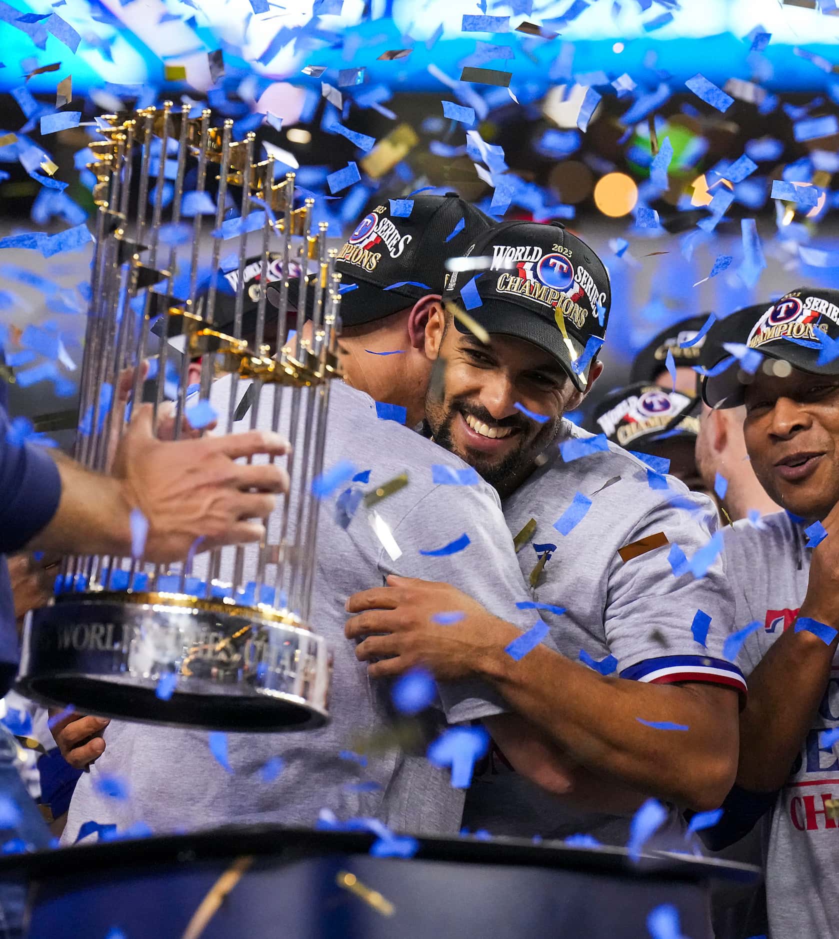 Texas Rangers’ Marcus Semien (center) celebrates as general manager Chris Young lifts the...