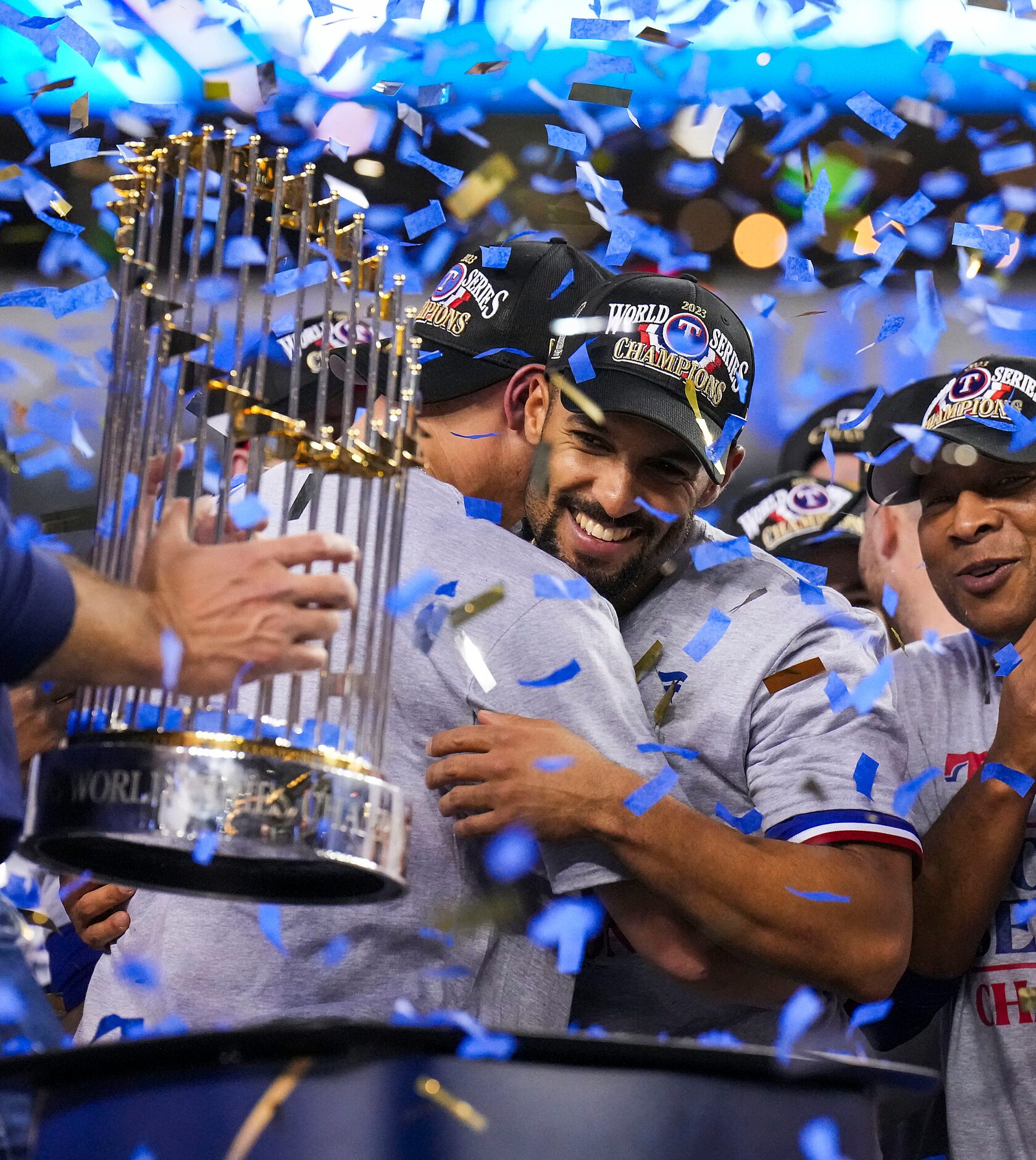 Texas Rangers’ Marcus Semien (center) celebrates as general manager Chris Young lifts the...